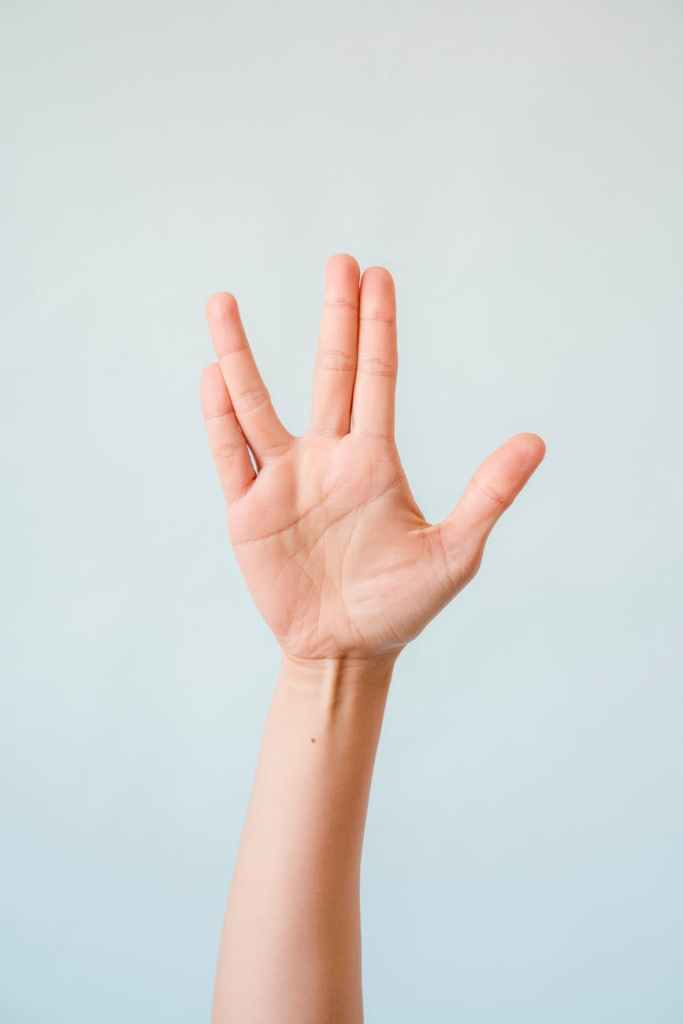 close up of a raised hand doing the vulcan salute